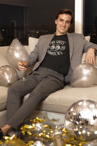 t-shirt-mockup-of-a-man-relaxing-on-a-couch-during-an-nye-party-m20084